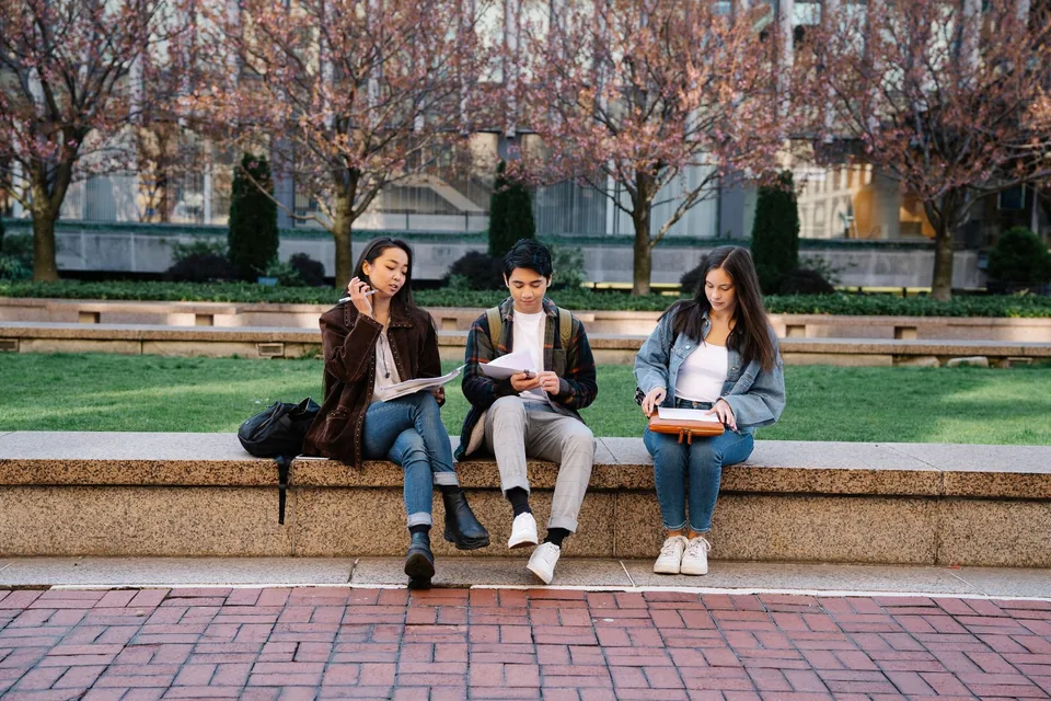Students studying together on a landscaped campus